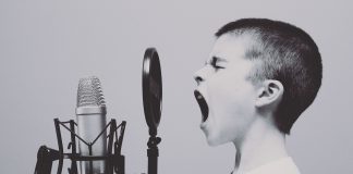 child yelling into a microphone