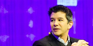 Uber CEO travis kalanick sitting on a chair with his hands crossed at chest level