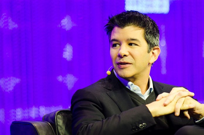 Uber CEO travis kalanick sitting on a chair with his hands crossed at chest level