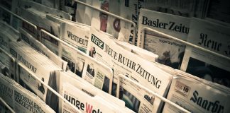 newspapers on display in a news stand
