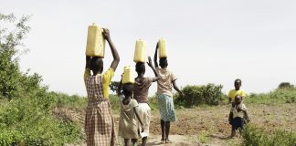 people carrying water in baskets