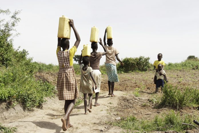 people carrying water in baskets