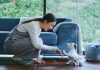 Woman playing with the Sony aibo AI puppy